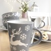 Pair of grey and white reindeer mugs with spoons