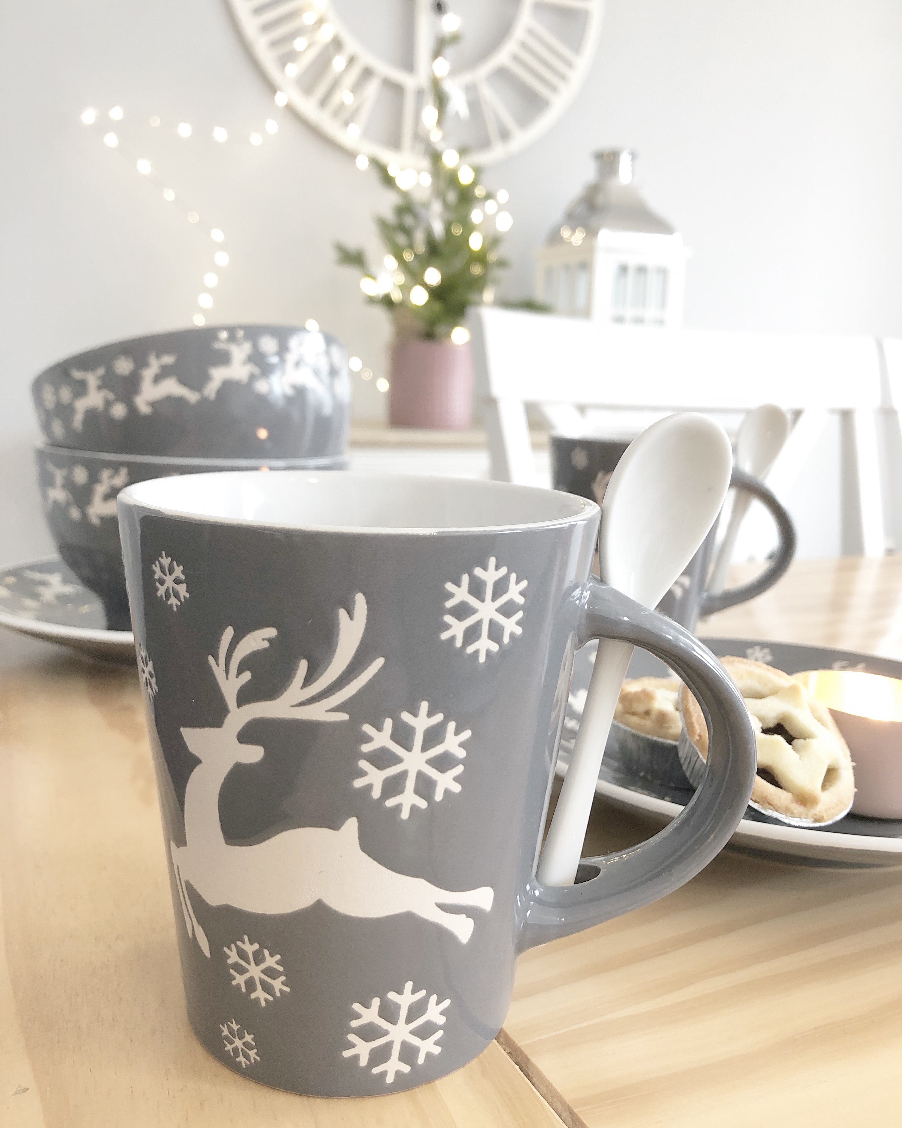Pair of grey and white reindeer mugs with spoons