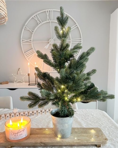 Faux Christmas tree with LED lights in silver pot