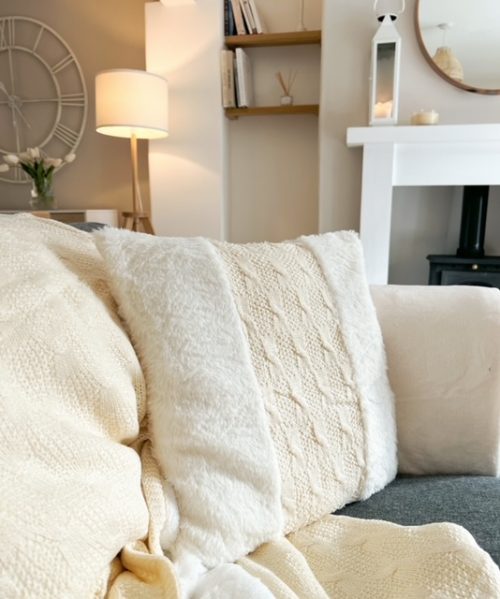 Plush cream faux fur and cable knit cushion