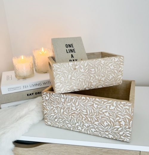 A pair of decorative storage crates with handles
