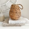 Woven lantern with glass votive and rope handle